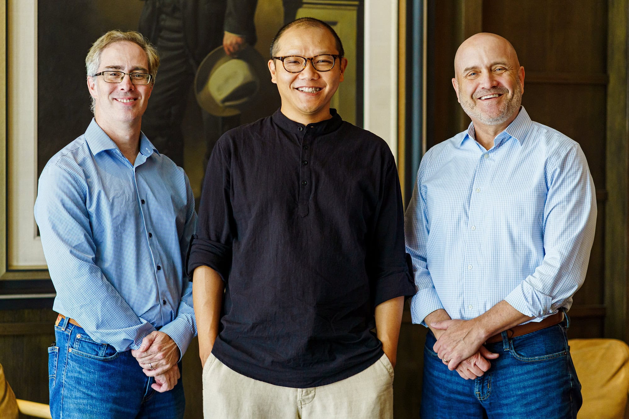 Neal Dikeman, Q Song, and Craig Lawrence standing together in casual dress.