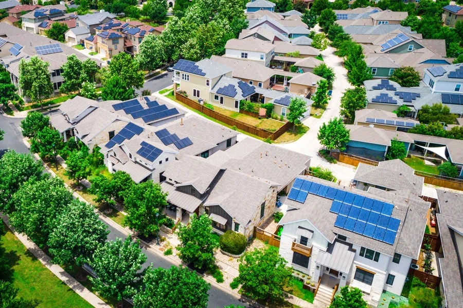 Aerial view of neighborhood with solar panels.